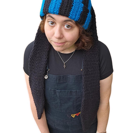 The image features a crocheted beanie with extra long bunny ears in a black and sapphire blue striped pattern; with the ears hanging down.